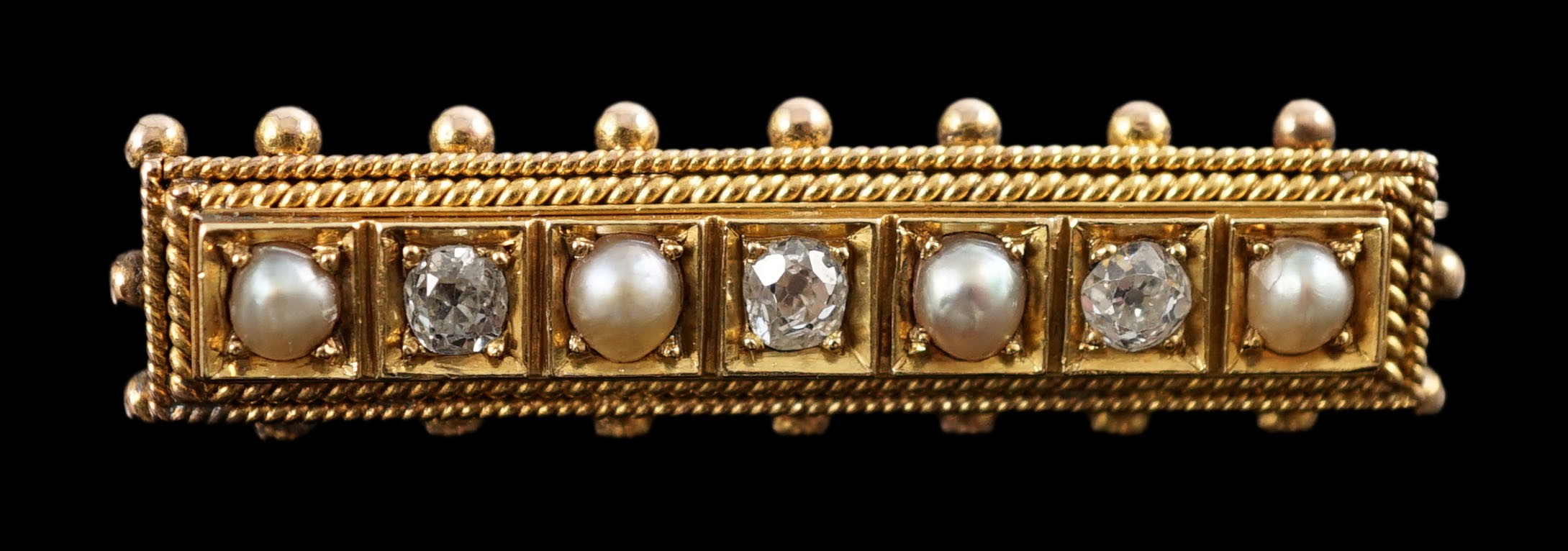 An early 20th century gold three stone diamond and four stone split pearl set bar brooch